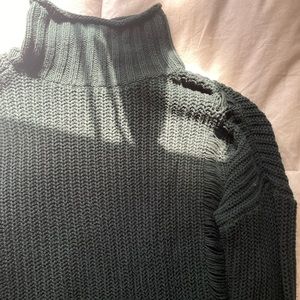 Dark green turtle neck sweater.